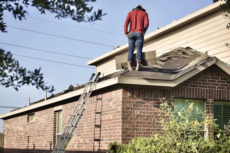 Professional roofer working on a residential roof in Charolais Acres